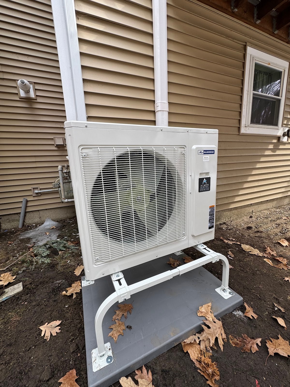 Ductless mini-split condenser wired beside a home by Almon Electric