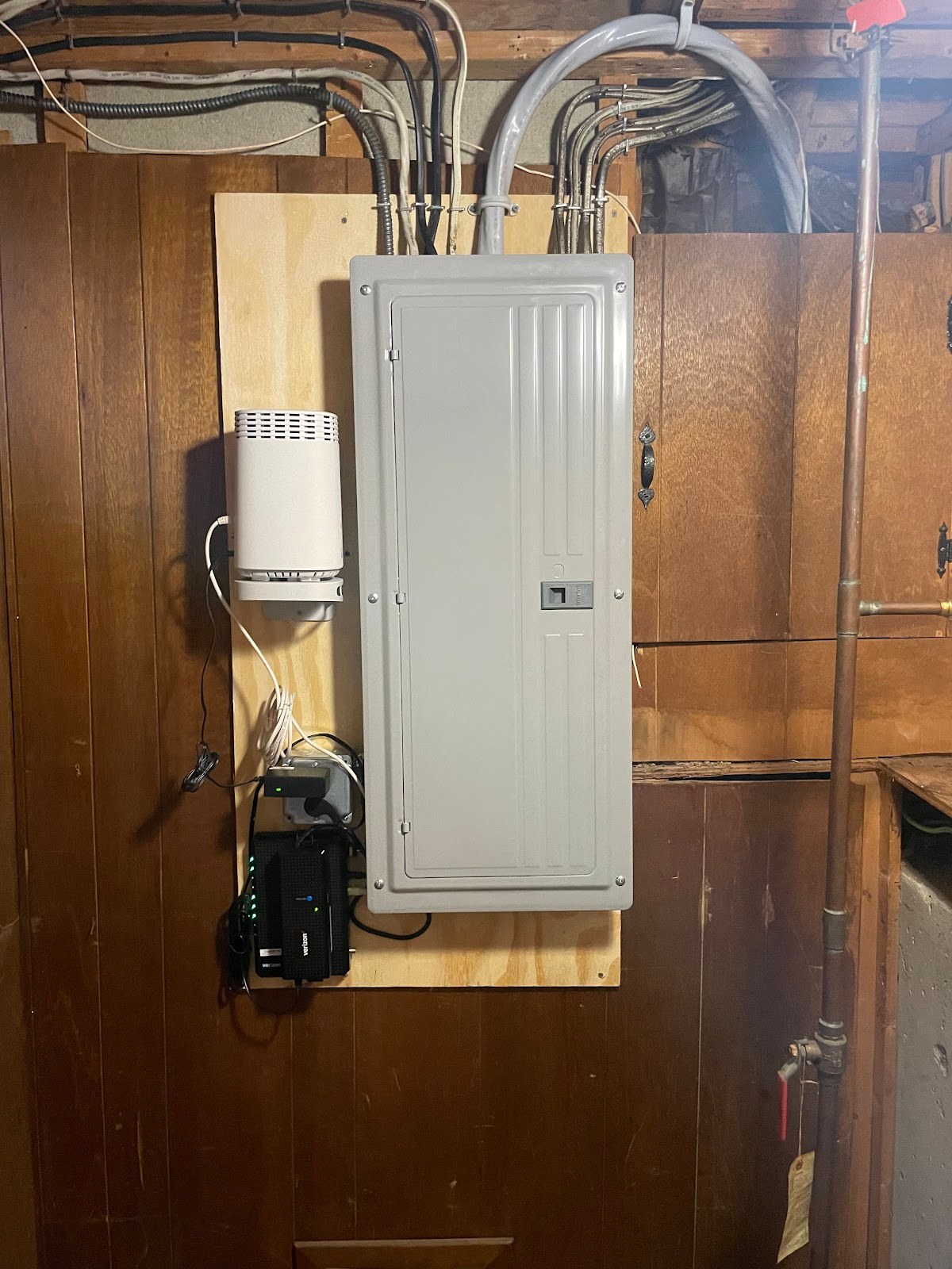 New electrical panel installed on a basement backboard by Almon Electric